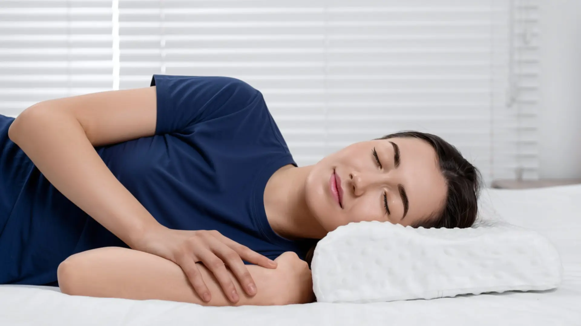 Woman sleeping on contour pillow