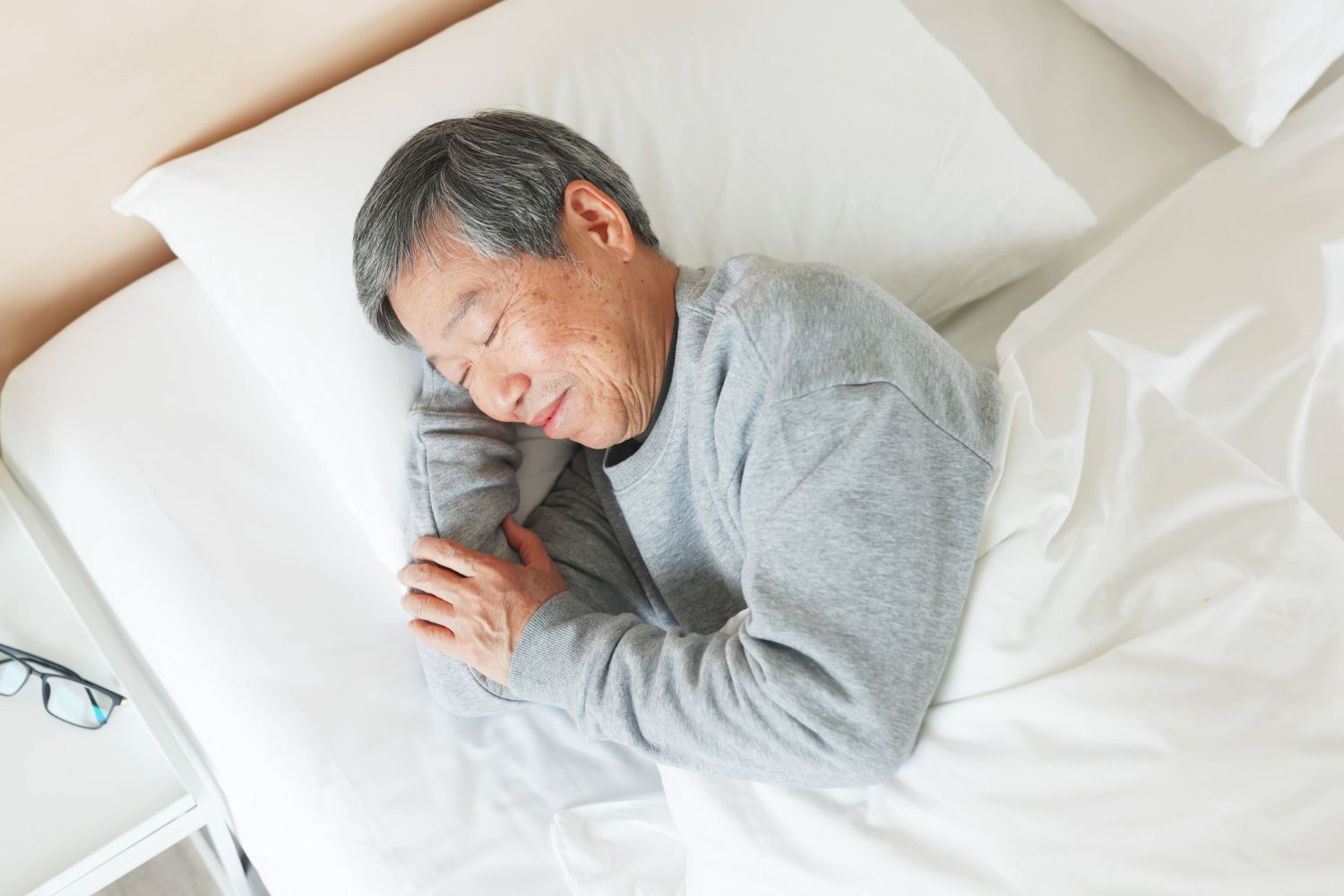 Senior man asleep in bed